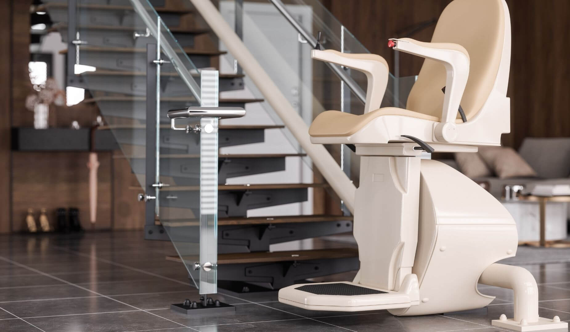 A sleek, modern stairlift with a beige seat, parked at the bottom of a contemporary staircase with glass panels.