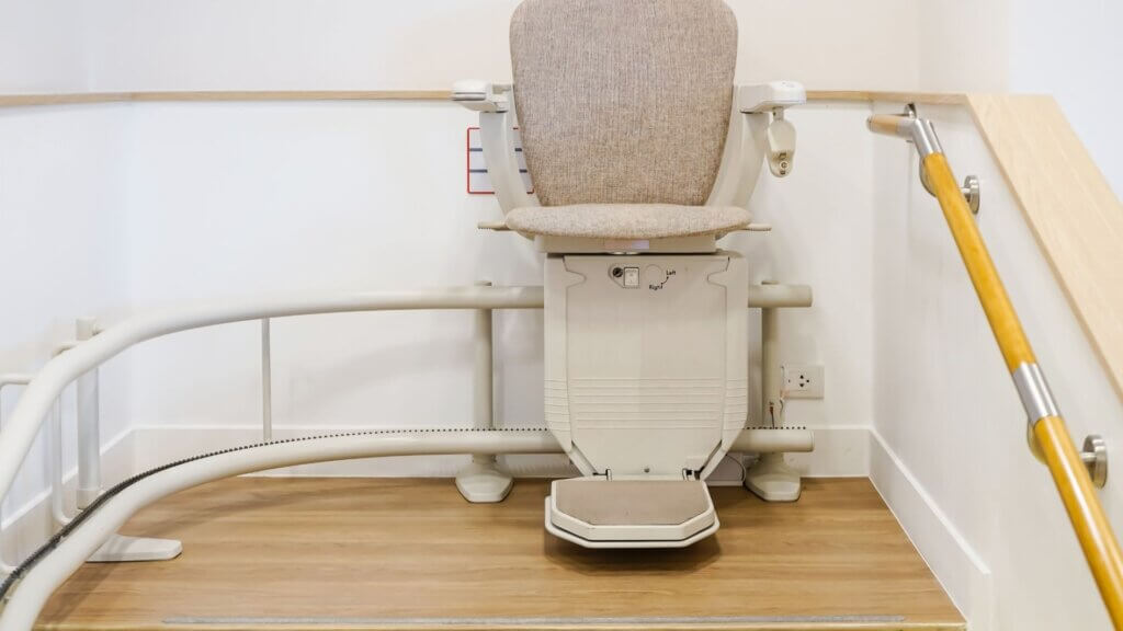 A stairlift installed on a wooden landing.