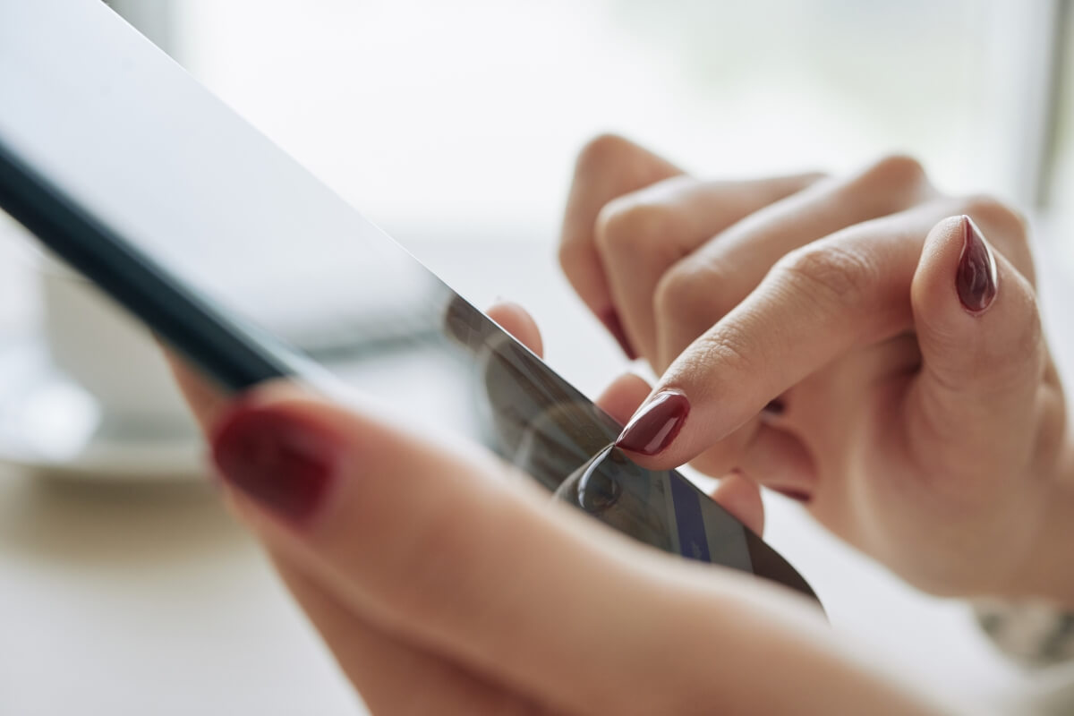 Close-up of a person's hands using a smartphone.