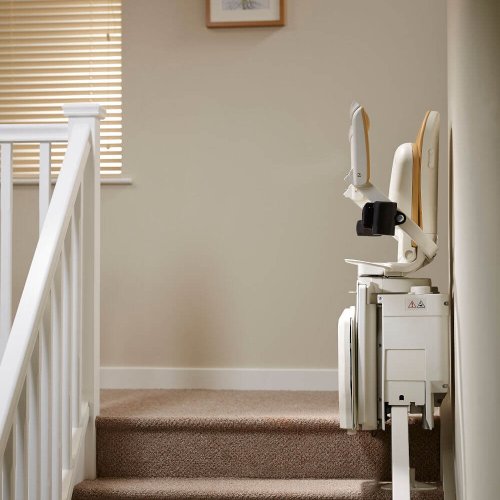 Stairlift at top of stairs folded up